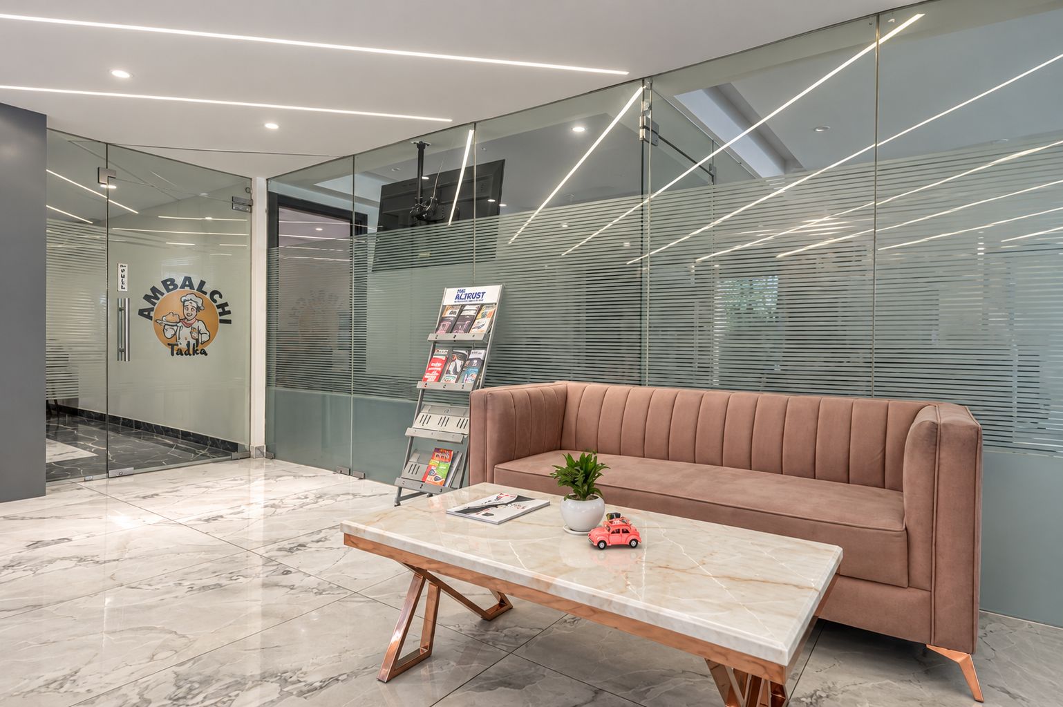 A modern reception area with a marble floor, a sofa, a coffee table, and a glass wall with blinds.