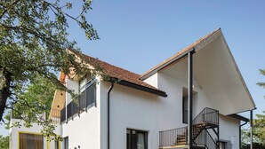 A two-story house with a balcony, a staircase, and outdoor seating. - Major's House Hotel (Step'anavan)