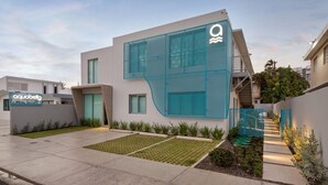 A modern building with a unique glass facade and a sign for 'aquabella'.