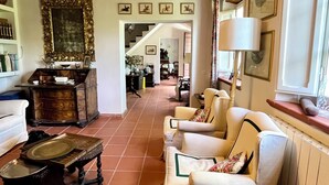 A cozy living room with a fireplace, a sofa set, and a dining table.