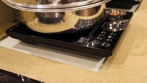 A kitchen with stainless steel cookware on a stove. - OPO PREMIER (New Delhi)