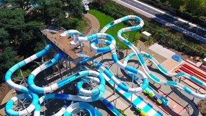 A water park with multiple interconnected water slides and a wooden deck area. - Holiday Home in France with Private Terrace (Mauroux)