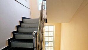 A staircase with a metal handrail and a window at the top. - Divy Dhaam Near Prem Mandir (Vrindavan)