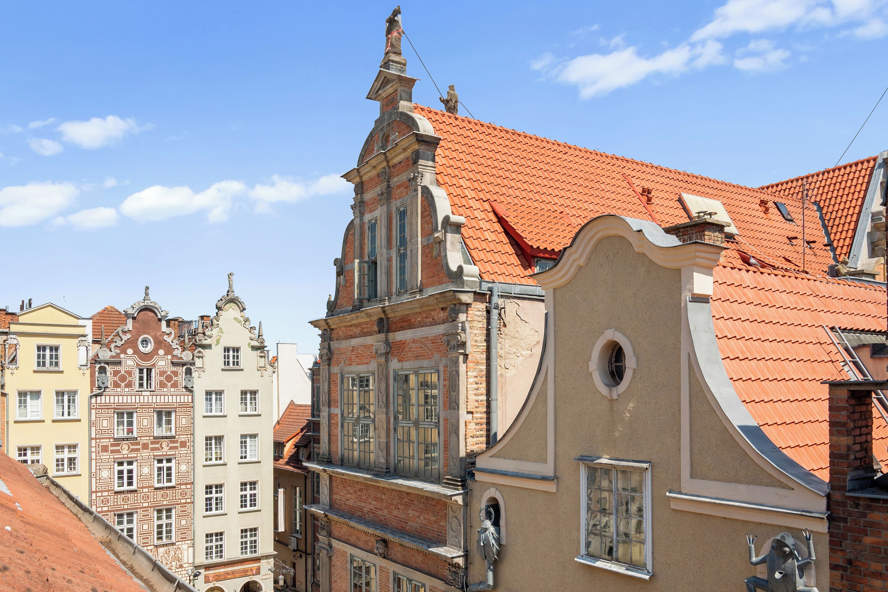A historic building with ornate architectural details and a red-tiled roof.