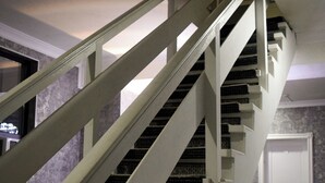 A staircase with white railings and a carpeted landing. - Continent (Karagandy)