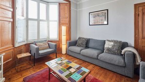 A living room with a grey sofa, a patterned coffee table, and wooden flooring. - Host Stay Park Terrace (Whitby)