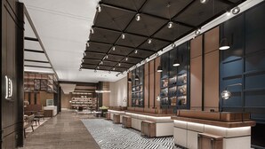 A modern hotel lobby with a long reception desk, seating area, and a patterned floor. - Four Points by Sheraton Chengdu, Chunxi Road (Chengdu)