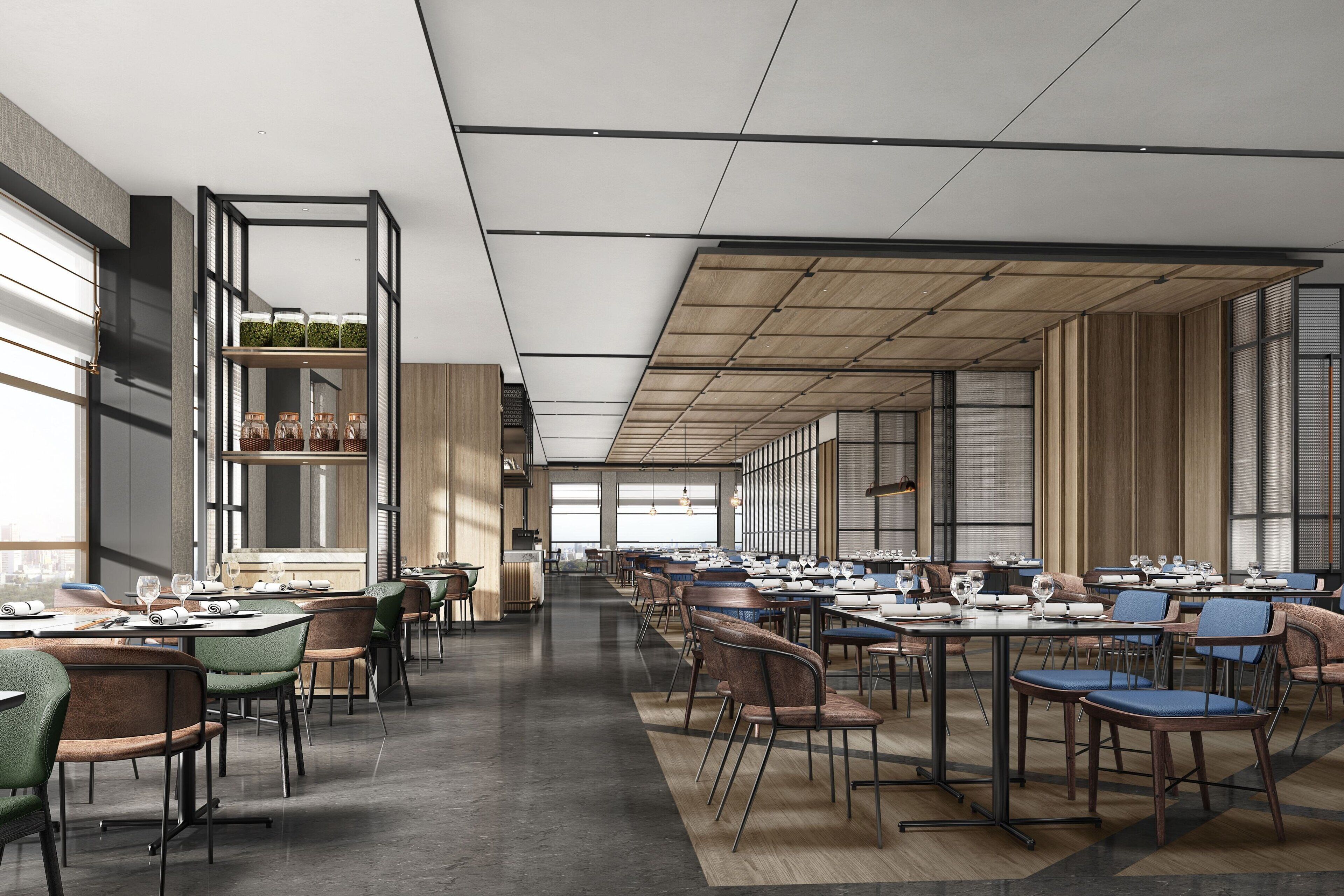 A spacious conference room with multiple tables and chairs, large windows, and a modern design.