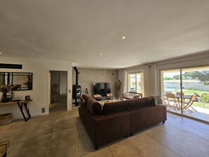 A modern living room with a sofa, TV, and a fireplace.