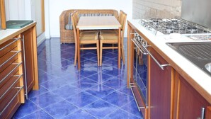 A kitchen with a dining table, chairs, and a stove. - DOMUS HORTENSIA AT THE VATICAN (Roma)
