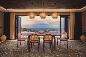 Enjoy meals with friends and family in this spacious dining area, surrounded by wicker chairs and natural light.