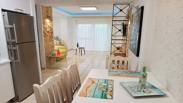 Deluxe Apartment | Living area | 32-inch Smart TV with digital channels