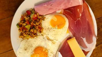 A plate with eggs, ham, cheese, and a vegetable mix.