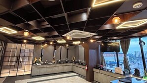 A modern hotel lobby with a marble floor, a reception desk, and a city view through large windows. - Transitel A Boutique Hotel (Barasat)
