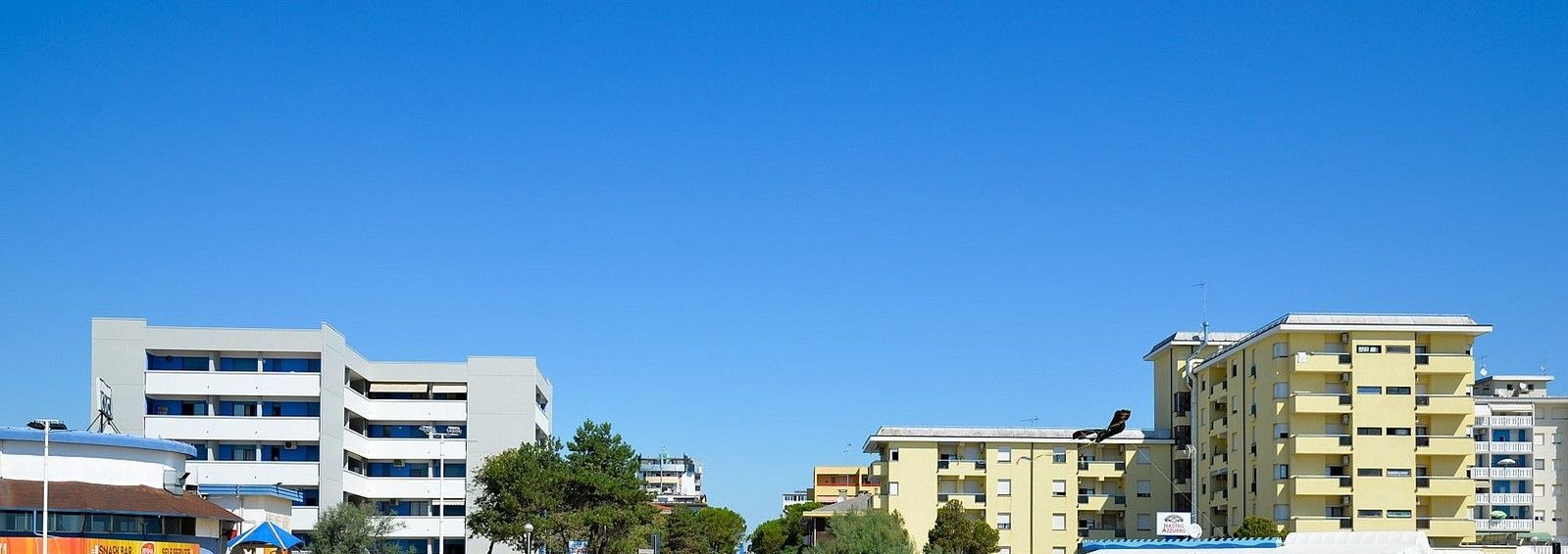 A row of multi-story buildings with balconies, likely residential or mixed-use.