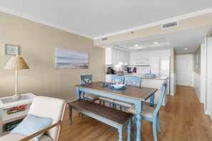 Enjoy a spacious living area with a dining table, kitchen, and comfortable seating.