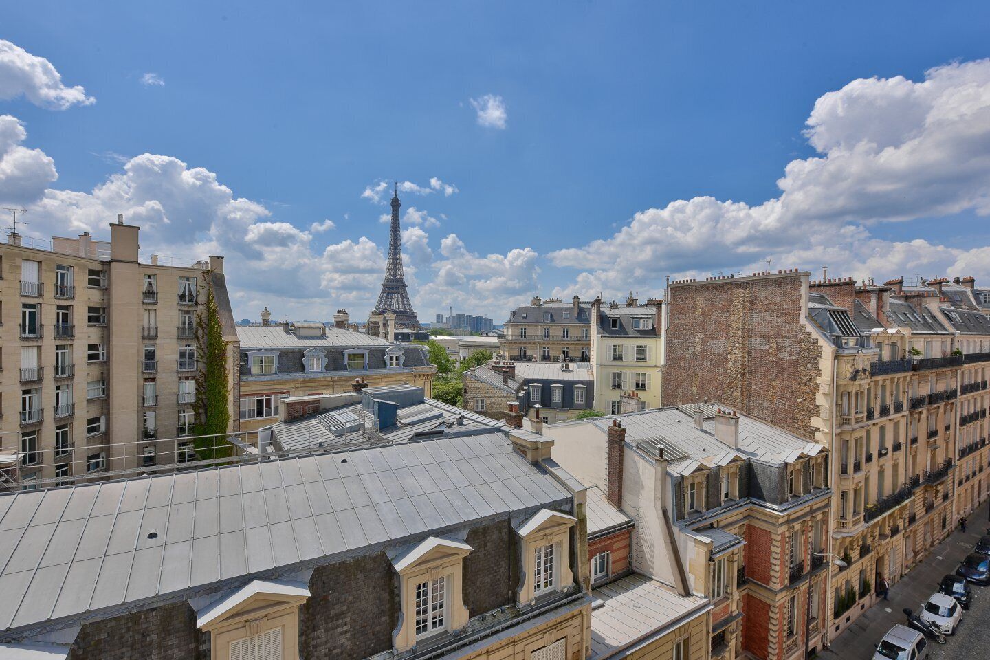 A high-rise building with a view of the Eiffel Tower in the background.