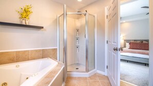 A modern bathroom with a walk-in shower, a bathtub, and a shower curtain. - Family Retreat in Birmingham – 7BR/4BA (Birmingham)
