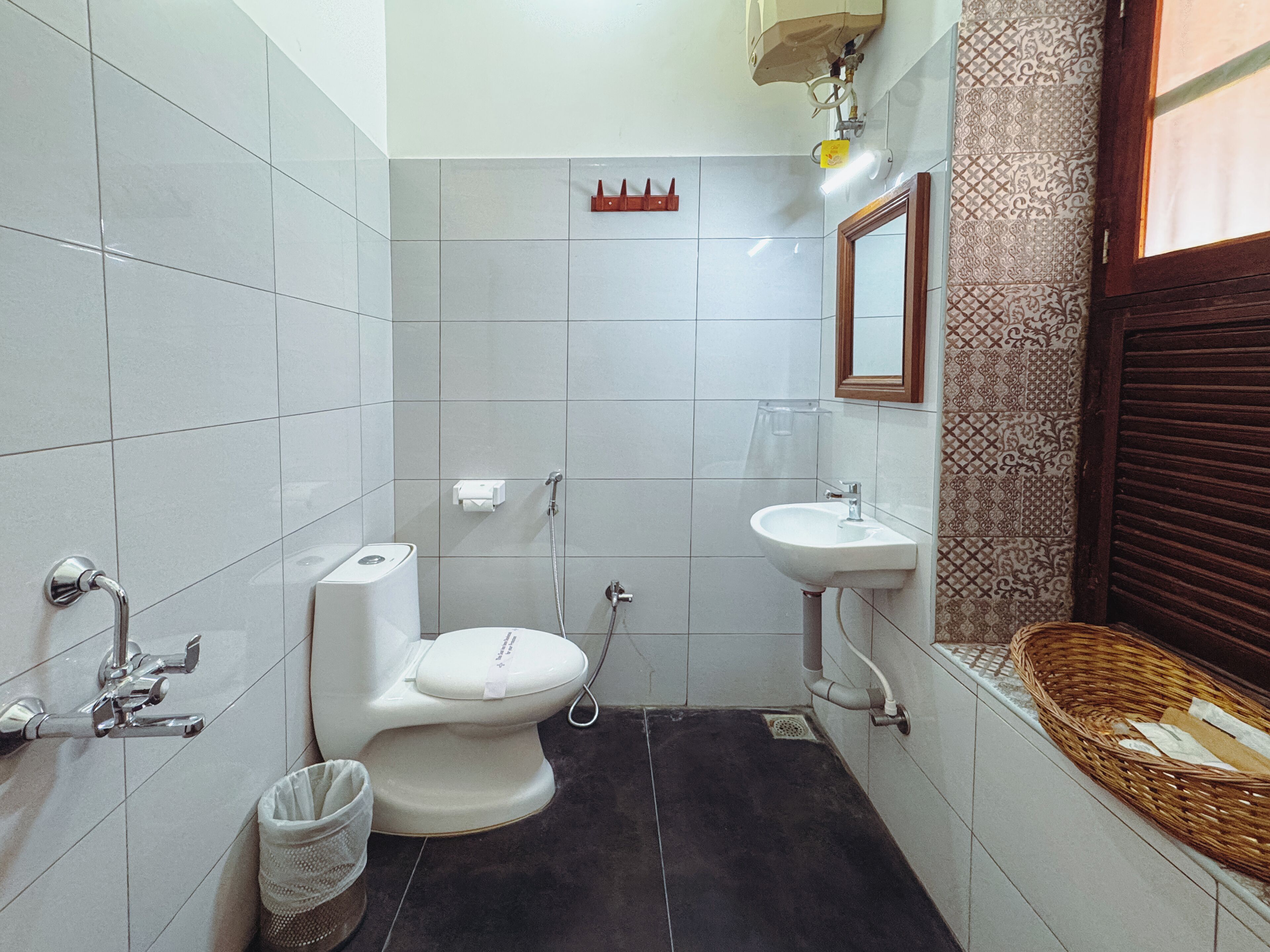 A compact bathroom with a toilet, sink, and shower.