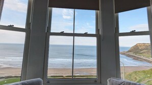 A room with a large bay window overlooking a beach and ocean. - The Clarence Gardens Hotel, BW Signature Collection (Scarborough)