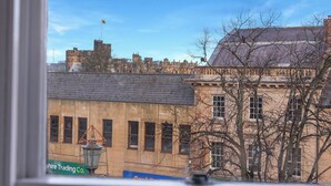A view of a historic building with a flag, a lamp post, and a sign for 'Shire Trading Co.' - Darjeeling - North East Escapes (Alnwick)