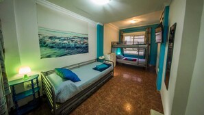 A compact room with a bunk bed, a single bed, a painting on the wall, a bedside table with a lamp, and a window with curtains. - Casa Pueblo Alzira (Alzira)