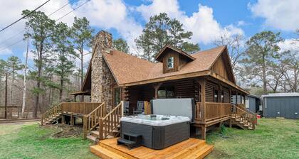 Relax at this lakefront log cabin on private Emerald Isle, designed for easy outdoor living. Enjoy the hot tub, paddle out with kayaks and canoes, gather around the fire pit, or grill and unwind by the water.