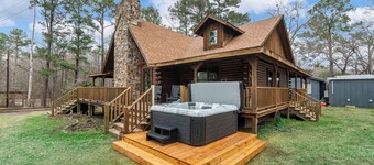Relax at this lakefront log cabin on private Emerald Isle, designed for easy outdoor living. Enjoy the hot tub, paddle out with kayaks and canoes, gather around the fire pit, or grill and unwind by the water.