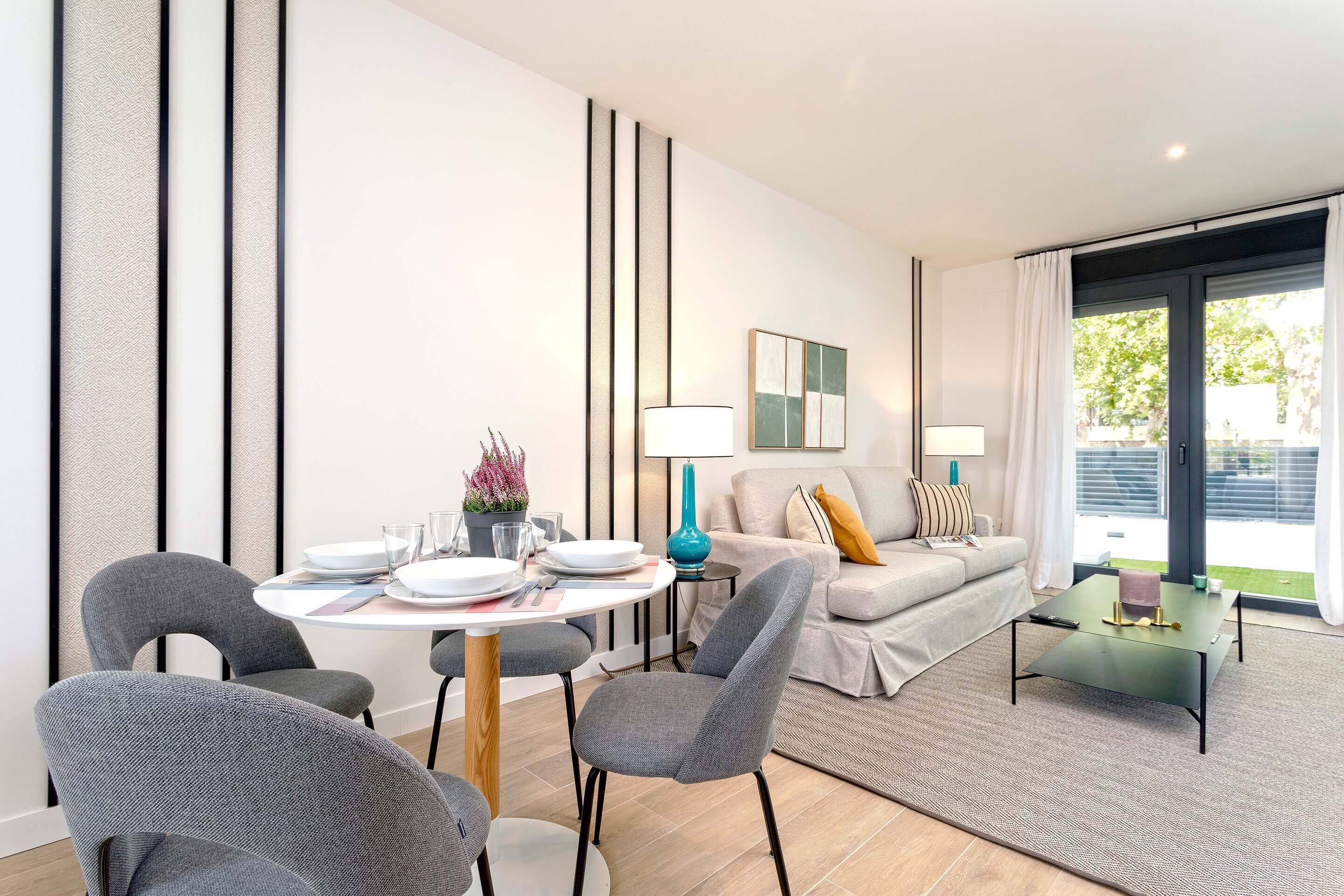 A modern living room with a dining area, featuring a sofa, a coffee table, and a dining table with chairs.