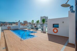 A rooftop pool with a clear view of the cityscape in the background. - Genteel Home María Zambrano (Málaga)