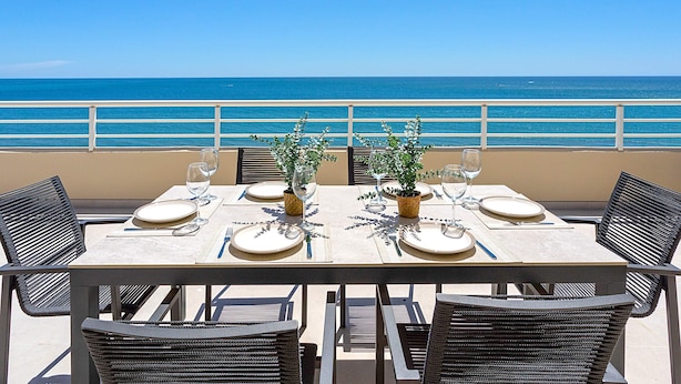 Une table dressée pour deux, avec vue sur l’océan.