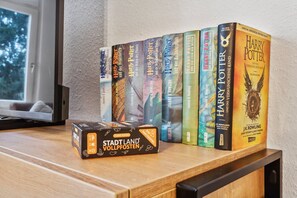 A collection of Harry Potter books on a wooden shelf.