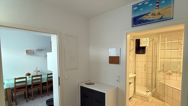 A room with a dining area, a small kitchenette, and a shower area. - Panorama 180° (Unknown)