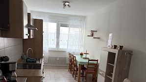 A compact kitchen with a dining area, a sofa, and a small table. - Panorama 180° (Unknown)