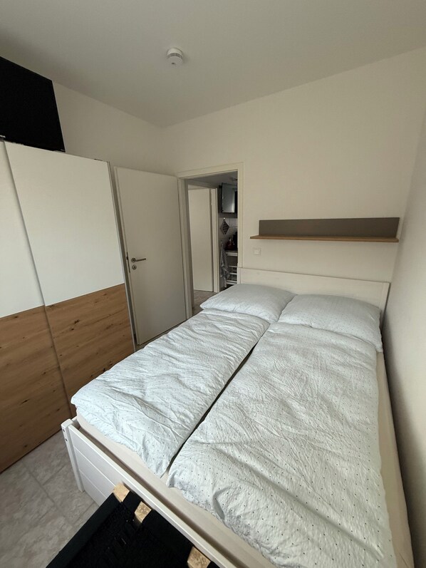 A bedroom with a bed, a wardrobe, a closet, and a shelf. - Panorama 180° (Unknown)