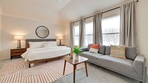 A bedroom with a bed, bedside tables, a lamp, a sofa, a coffee table, and a window with curtains. - 4 Mi to Dtwn: Family Home w/ Games in Frisco (Frisco)