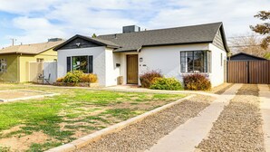 A modern two-story house with a well-maintained lawn and gravel driveway. - 1 Mi to Grand Ave: Modern Home w/ Spacious Yard! (Phoenix)