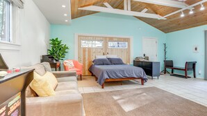 A bedroom with a bed, a desk, a chair, a sofa, and a large window. - Drive to Major Parks: Nature Getaway in West Point (West Point)
