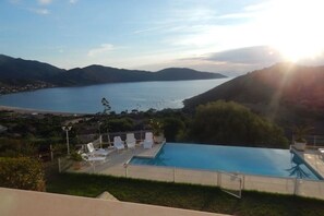 A swimming pool with a view of a lake and mountains. - T4 GOLFE DE LAVA BORD DE MER AVEC PISCINE (Appietto)