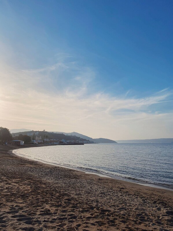 A beach with a clear sky and calm sea.