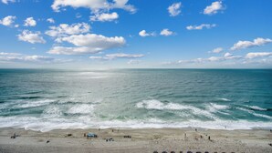 A beach with waves, clear sky, and people. - 🌊Newly Renovated Oceanfront | Awesome Amenities | Caribbean Resort 1405🌊 (Myrtle Beach)