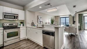 A modern kitchen with stainless steel appliances, a dishwasher, and a large island with a sink. - 🌊Newly Renovated Oceanfront | Awesome Amenities | Caribbean Resort 1405🌊 (Myrtle Beach)