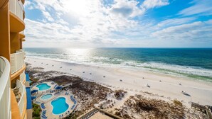 A beachfront hotel with multiple swimming pools, a sandy beach, and ocean views. - Phoenix Gulf Towers 1105 4 Bedroom Condo (Orange Beach)