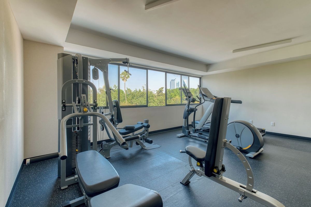 Bright building gym with cardio and strength gear, stay active steps from your door
