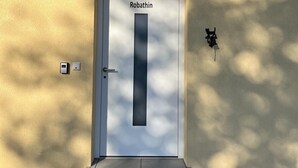 A door labeled "Robathin" with a keypad and a card reader on the wall beside it. - Penta Apartments (Gamlitz)