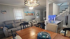 A dining area with a wooden table, chairs, and a decorative glass centerpiece.