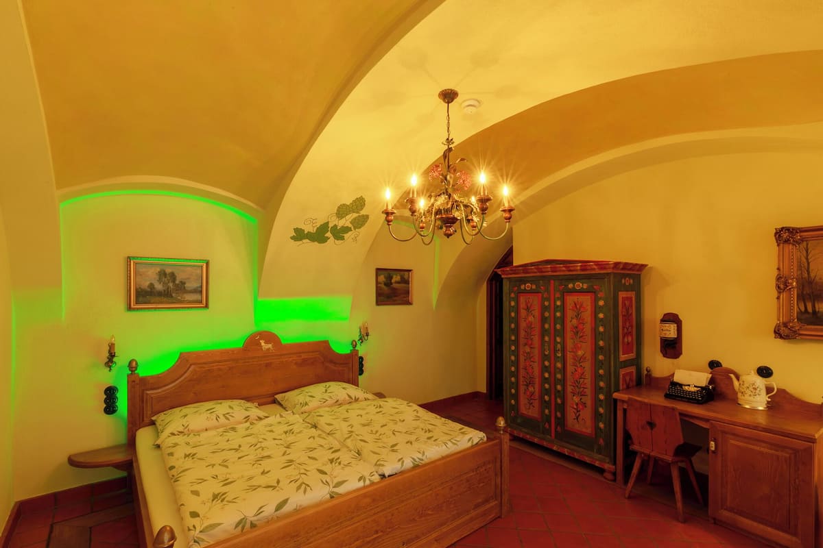 Une chambre à coucher avec un lit en bois, un bureau et une armoire.