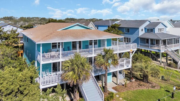 A two-story house with a balcony and a covered porch. - Haney's Penthouse - Tri-plex, 4-bedroom (Pawleys Island)