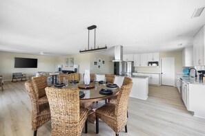 A modern kitchen with white cabinets, a stainless steel range hood, and a built-in oven. - Haney's Penthouse - Tri-plex, 4-bedroom (Pawleys Island)