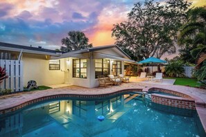 A modern house with a swimming pool, outdoor seating, and a view of the sky. - Tropical Getaway | Heated Pool & Patio Retreat (Fort Lauderdale)